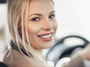 Young Woman Smiling In Car